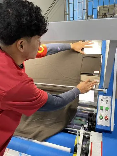 Operator inspecting fabric on a light table
